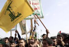 Demonstrators carry the Houthi and Hezbollah flags during a demonstration in support of Gaza and Lebanon in Al Sabeen Square in Sanaa 01