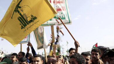 Demonstrators carry the Houthi and Hezbollah flags during a demonstration in support of Gaza and Lebanon in Al Sabeen Square in Sanaa 01