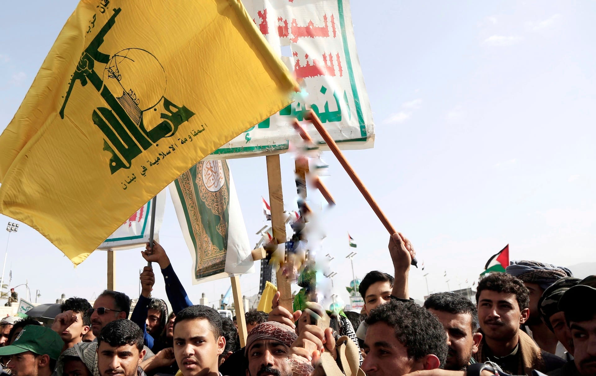 Demonstrators carry the Houthi and Hezbollah flags during a demonstration in support of Gaza and Lebanon in Al Sabeen Square in Sanaa 01