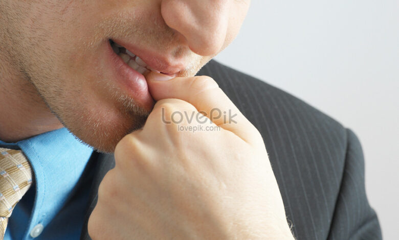lovepik businessman biting his nails picture 501498474